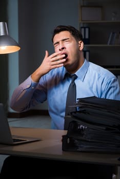 Employee working late at night at important report
