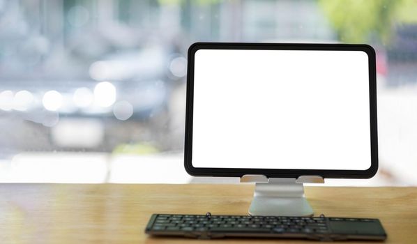 Blank screen Laptop computer and poster workspace background in modern office.