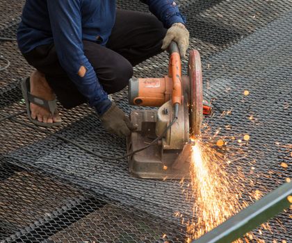worker used cutting machine to cut iron mesh