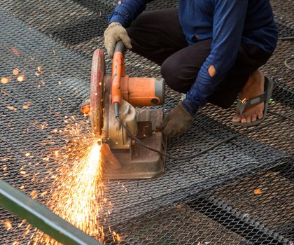 worker used cutting machine to cut iron mesh