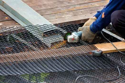 worker used cutting machine to cut iron mesh