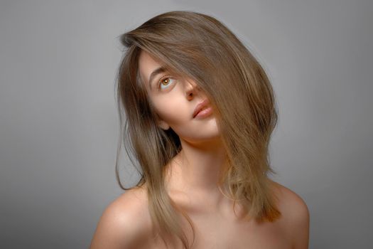 beautiful serious woman portrait, brunette hair cover her half of face