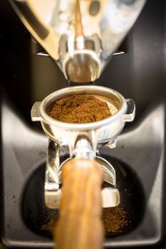 Professional coffee mill machine for making espresso in a cafe.