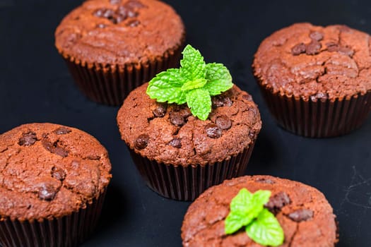 chocolate muffin with mint on a wooden table