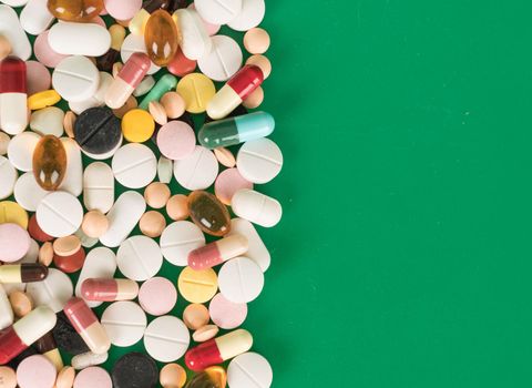 Colorful capsules and pills with copy space