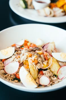 Tuna salad with egg in white bowl - Healthy food style