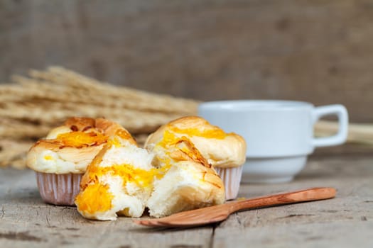 Muffin golden threads with wood fork and black coffee on wood table. Thai dessert call Foi Thong.