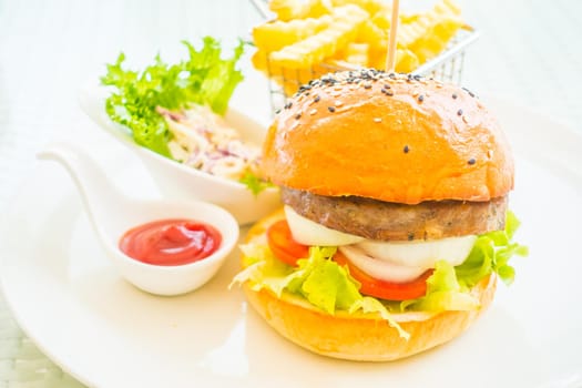 Selective focus point on beef hamburger with french fries - Junk food style