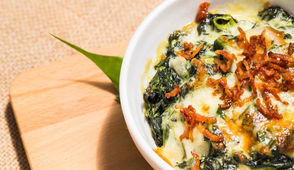 Bowl of fresh vegetarian spinach with cheese and fried minced sweet pork.