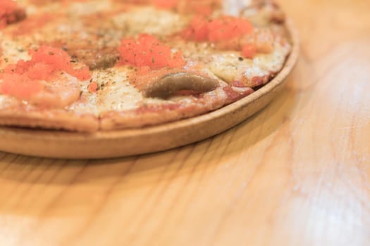 smoked salmon pizza on wood table