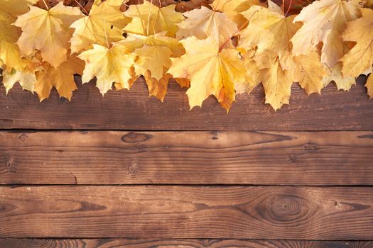 Autumn leaves frame on wooden background top view Fall Border yellow and Orange Leaves vintage wood table Copy space for text
