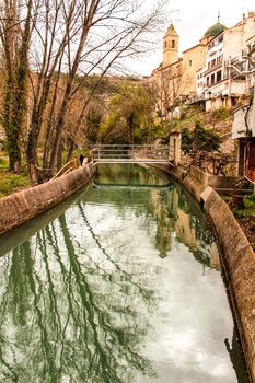 Water channel in Alcala del Jucar and vegetation