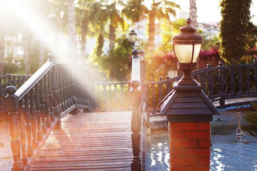 Summer background. Vacation concept. Summer holidays background. Bridge in a green park in Turkey Alanya. Lamp post near the bridge