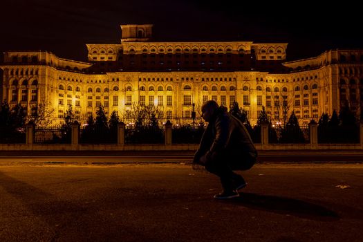 Man in front of Palace of Parliament, Bucharest, Romania