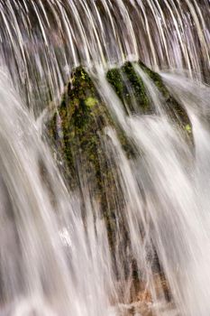 Beautiful veil cascading waterfalls, mossy rocks. close up picture