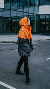 Girl in orange protective overalls and glasses. Air pollution and hazard concept