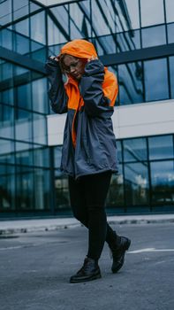 Girl in orange protective overalls and glasses. Air pollution and hazard concept