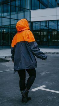 Girl in orange protective overalls and glasses. Air pollution and hazard concept