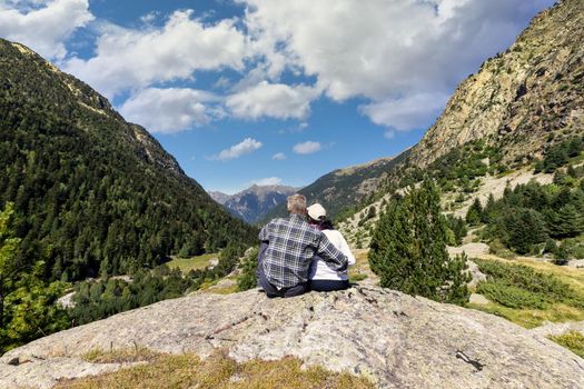 Beautiful Pyrenees mountain landscape, Sant Maurici and Augestortes, tourist couple, Spain, Catalonia.