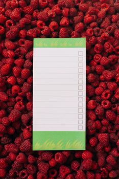 Empty sheet to insert dough, against the background of the texture of raspberries. High quality photo