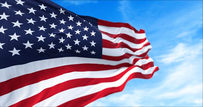 close up view of the american flag waving in the wind. Clear sky in the background. Selective focus. Democracy, independence and election day. Patriotic symbol of American pride