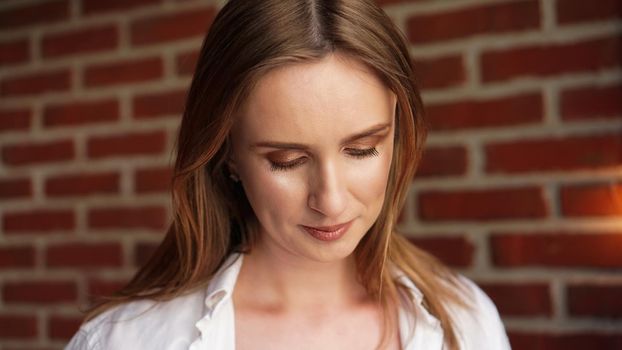 Close up Happy Young Woman Wearing Casual white shirt In Front red Brick Wall - Loft interior