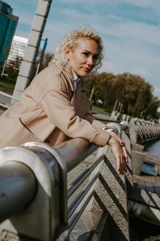 Stylish Pretty Young Woman in Autumn Fashion walking in the city