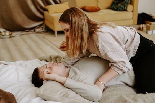 Business couple on bed in hotel room - tender hugs