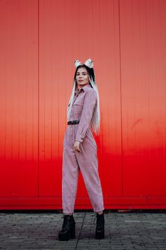 Beautiful cool girl with dreadlocks full length. Photo in the city - urban style