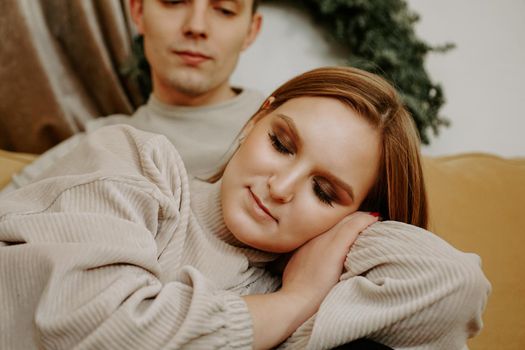 Photo of woman sleeping on the mans knees. Beautiful girl with makeup and eyes closed.