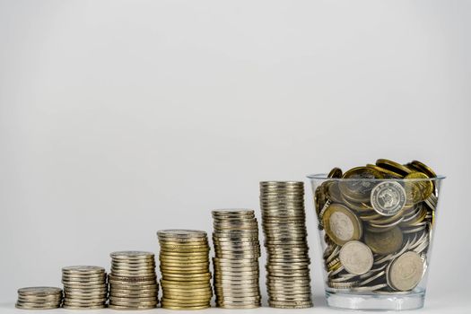 money saving, business financial growth, economy budget and investment concept. golden coins in jar and coin stack growth up on white background.
