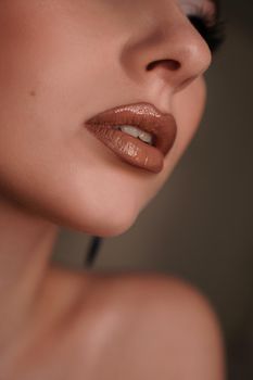 Close up of a female face - lips. Beauty portrait with professional makeup. Fashion portrait of a beautiful woman.