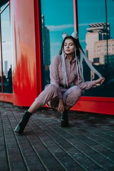 Beautiful cool girl with dreadlocks Photo in the city - urban style