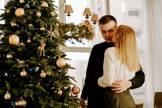 Picture showing young couple in love hugging over Christmas tree