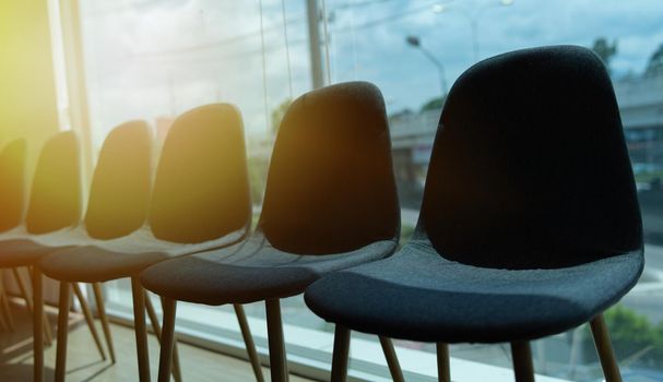 Job application and unemployment concept. Chairs and sunset background.