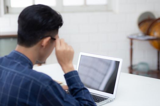 Young asian business man using laptop computer blank screen mockup for video call online and communicate work from home, male conference with notebook, social distancing, communication concept.