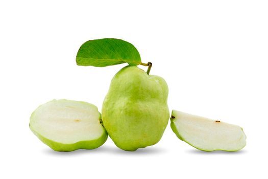 Group of fresh seedless guavas with green leaves and halved and sliced on white background.