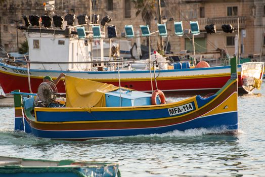 People are enjoying sunny day at Saint Peter's pool near Marsaxlokk, Malta