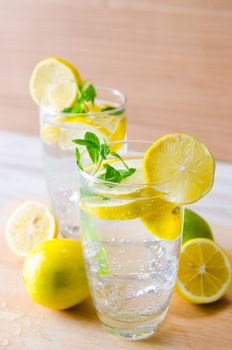 Glasss of mojito with lemon and drinking straw