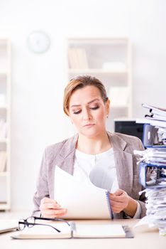 Businesswoman very busy with ongoing paperwork