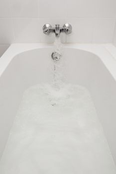 Luxury bath tub and faucet with water.