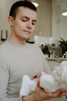 Young man with sculpture bust in an art workshop background