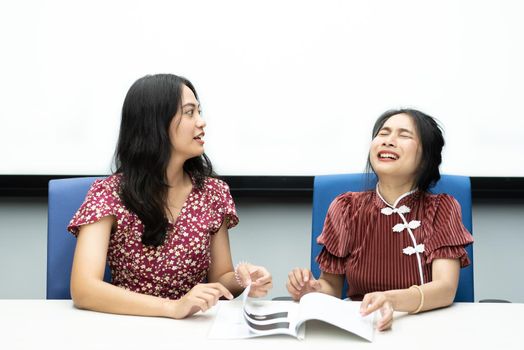 Asian pretty women in cheongsam chinese style great happy joyful and coworker discussion in meeting room in office with happy and smile in concept success, winner, successful or business