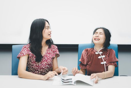 Asian pretty women in cheongsam chinese style great happy joyful and coworker discussion in meeting room in office with happy and smile in concept success, winner, successful or business