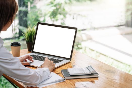 Businesswoman using laptop blank screen while working with calculator for financial. Clipping path.