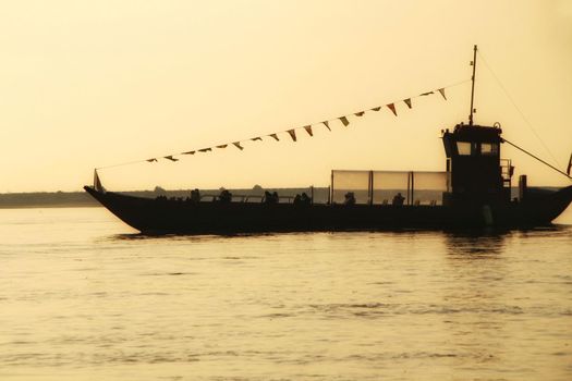 Typical portuguese boats called Rabelos crossing the Douro River in Porto at sunset