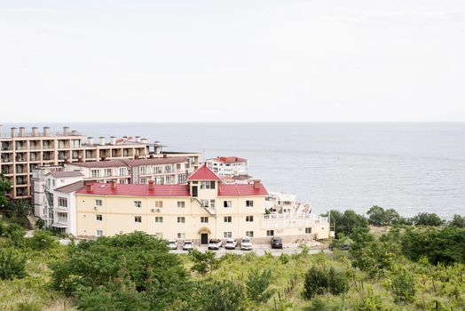 Hotel or apartment building on the seaside. Beautiful summer seaside landscape