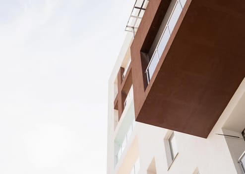 Hotel or apartment building on sky background