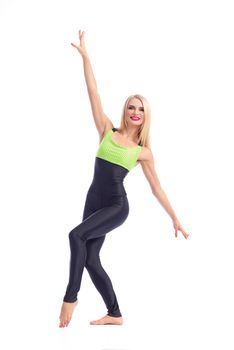 Fit girl. Attractive young cheerful blonde female aerobics instructor posing gracefully on white background