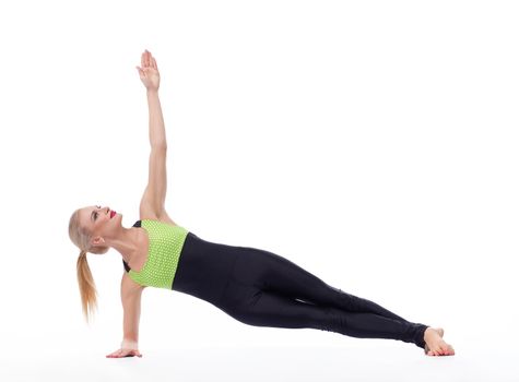 Perfect home workout. Attractive young active female doing yoga asana exercising in studio isolated on white copyspace yoga balance harmony strength fitness concept